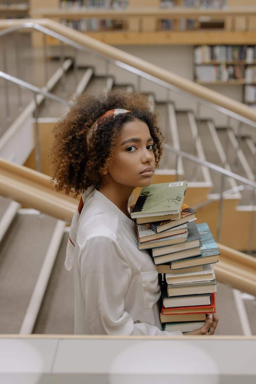 photo of woman standing on the staircase