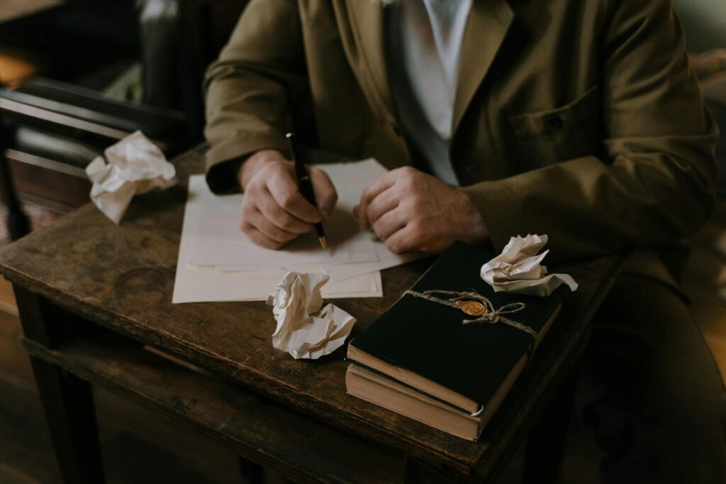 person writing on a white paper